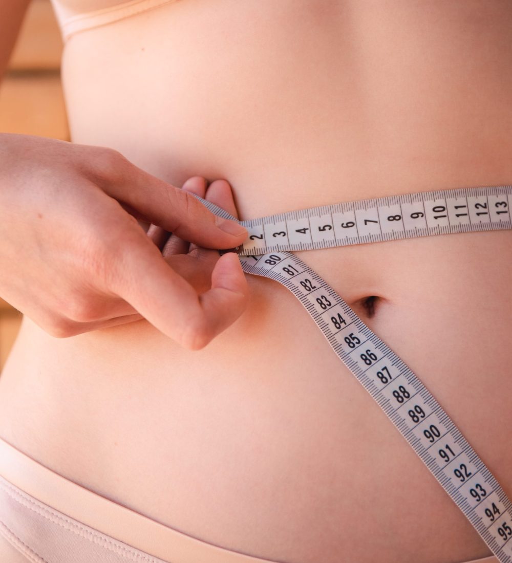 young-woman-measuring-her-waist-health-and-beauty-2021-09-19-17-22-26-utc